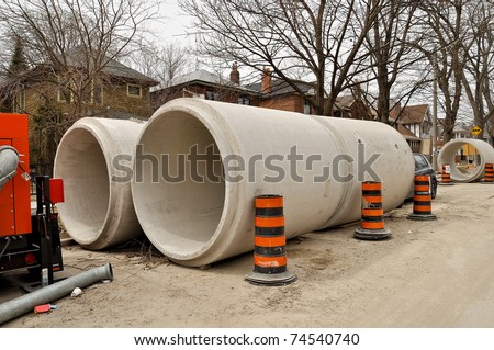 stock-photo-concrete-sewage-pipes-on-residential-street-74540740.jpg
