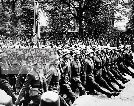846-02796499em-1940s-GERMAN-TROOPS-MARCHING-GOOSE-STEPPING-IN-STREETS-OF-WARSAW-POLAND-1941.jpg