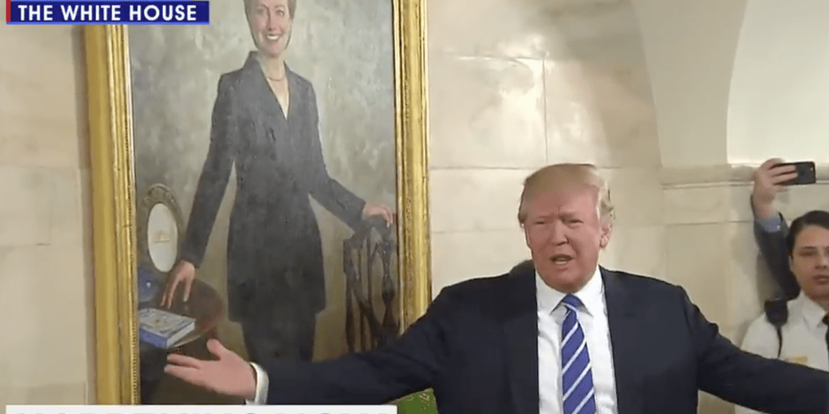 trump-surprises-white-house-tour-group-greeting-visitors-in-front-of-a-portrait-of-hillary-clinton.jpg