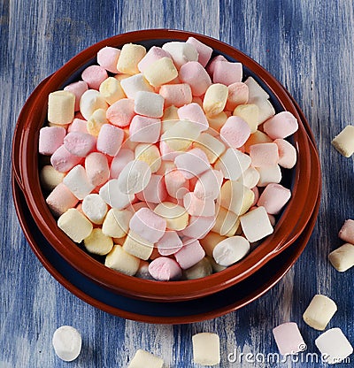 colorful-small-marshmallows-blue-wooden-background-top-view-54706121.jpg
