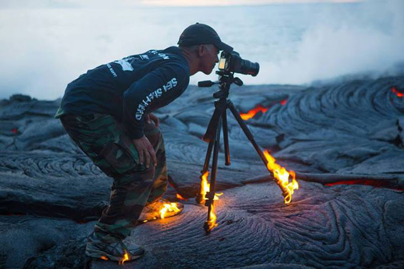 kawika-singson-standing-on-lava-shoes-tripod-on-fire.jpg
