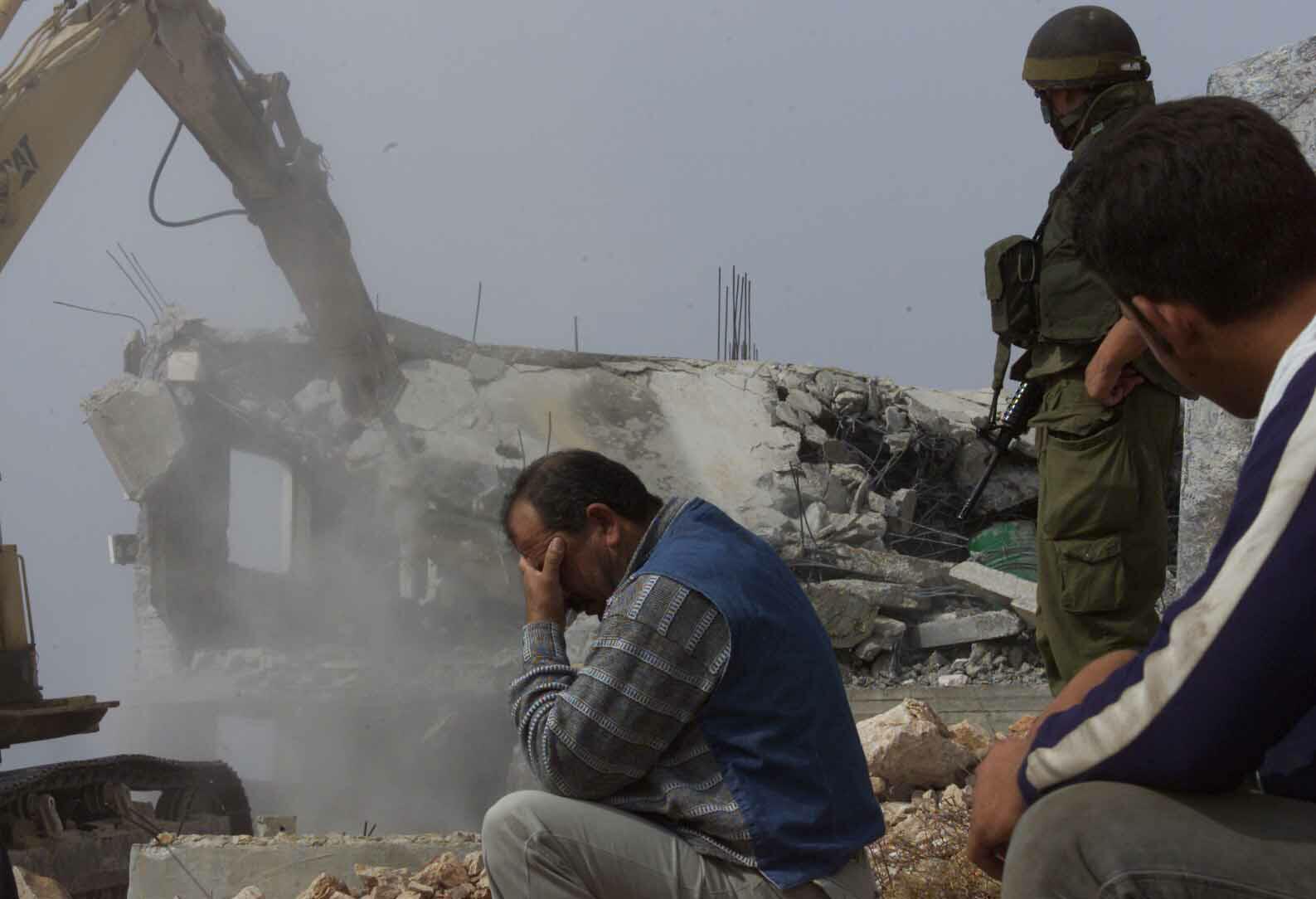 A-Palestinian-man-cant-look-as-his-home-is-demolished.jpg